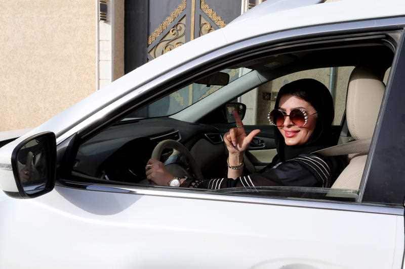 Huda al-Badri, 30, poses behind a steering wheel as women are alowed to drive for the first time through the streets of the capital, Riyadh.