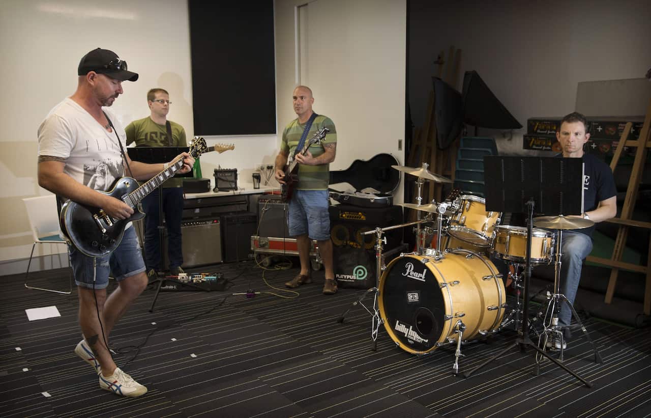 Australian Defence Force members play music together as part of the Arts for Recovery, Resilience, Teamwork and Skills program.