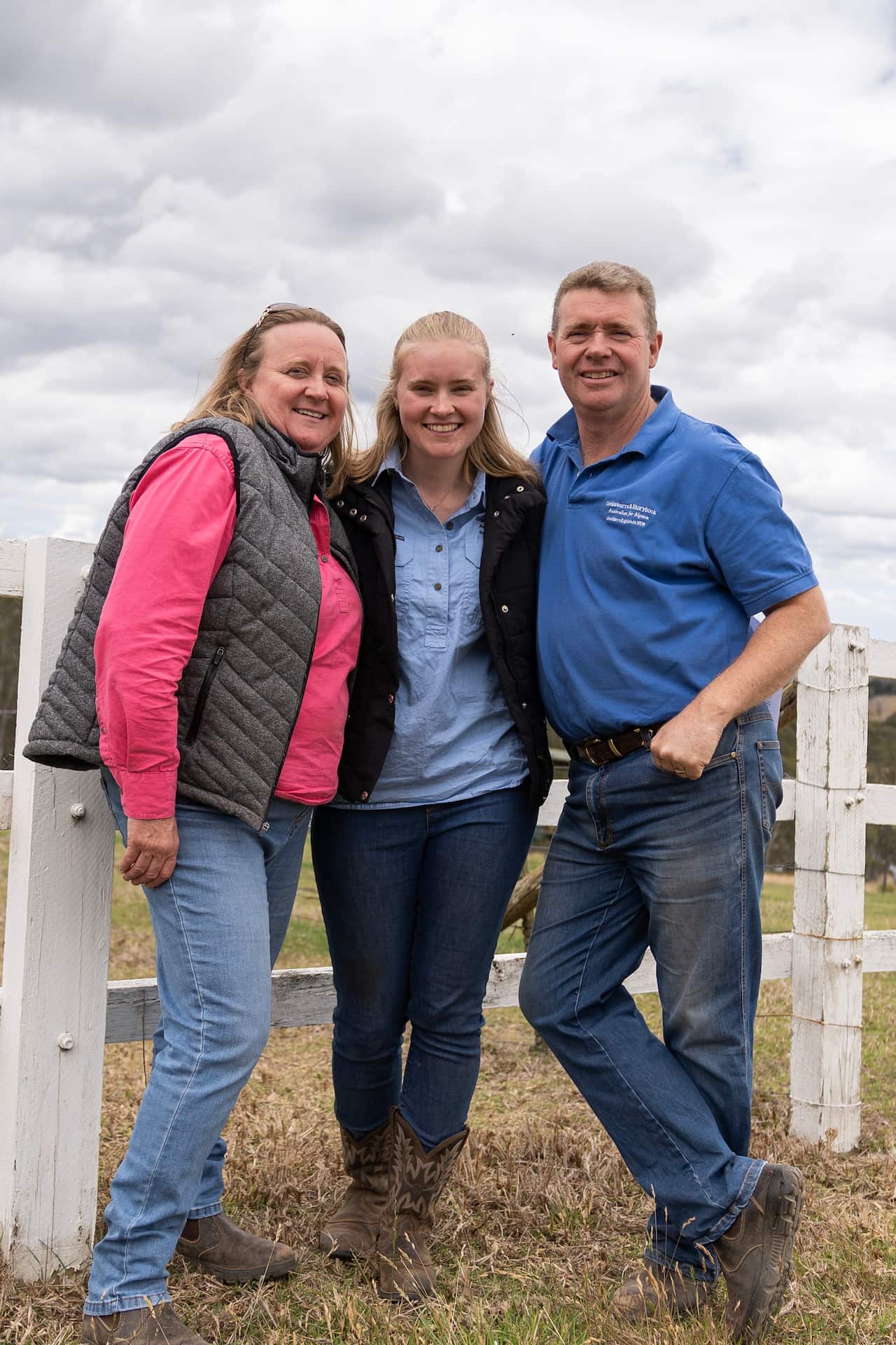 Rubey Williams (centre) with her parents Karen and Mick Williams on their family alpaca farm. 
