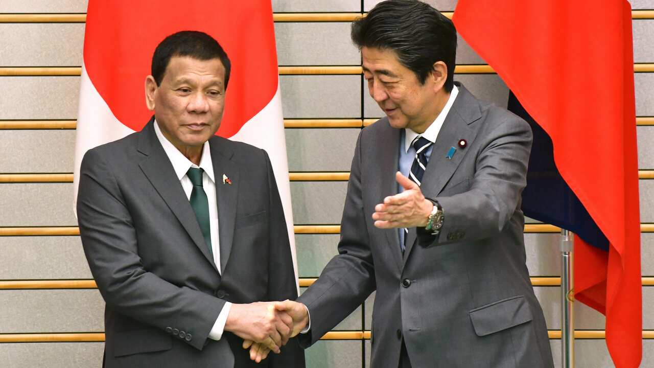 President of the Republic of the Philippines Rodrigo R.Duterte and Japan's Prime Minister Shinzo Abe shake hands during a meeting in Tokyo, Japan.