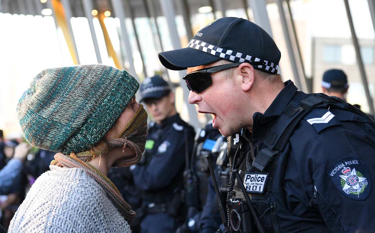Protesters clash with police outside the Melbourne Exhibition and Convention Centre.