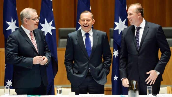 Then Prime Minister Tony Abbott laughs at an inappropriate comment from Peter Dutton about rising sea levels threatening Pacific Islands. 