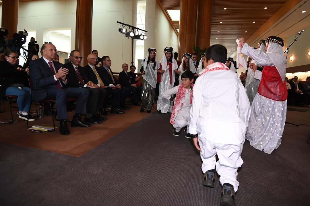 Peter Dutton watches Yazidi children dance during Refugee Week in 2017. 