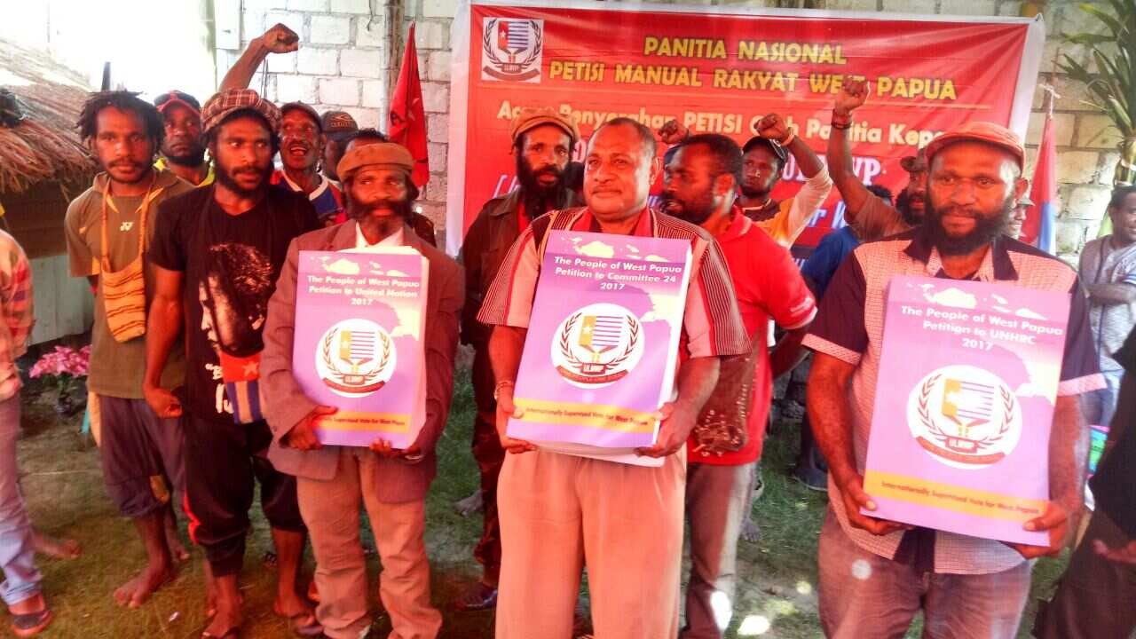 Supporters of West Papuan independence holding reams of the petition. 