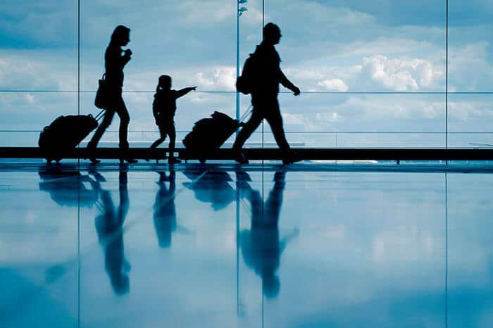 People walking through an airport terminal.