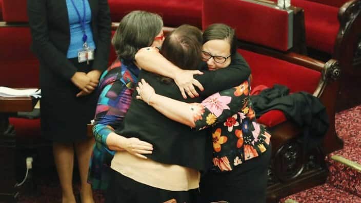 Victorian Upper House MPs hug after the voluntary assisted dying bill passes 