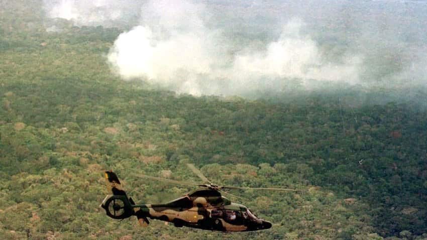 Members of the enviormental commision of the Brazilian Congress, fly in a army helicopter over an area of the Amazon forest affected by fires.