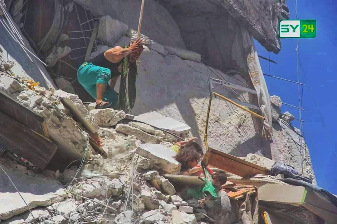 A Syrian father scrambles to rescue his two young daughters trapped in the rubble of their home after an air strike.