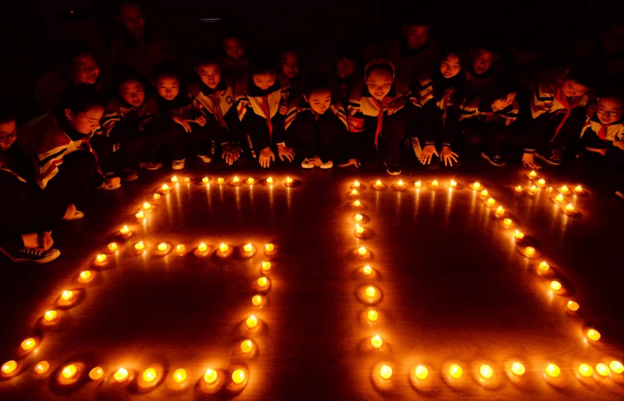 Students light candles to mark the Earth Hour, inspiring people to take action to protect and preserve the natural environment of the planet in north China.