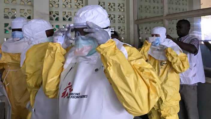 A team from Medecins Sans Frontieres (Doctors Without Borders) dons protective clothing and equipment as they prepare to treat Ebola patients. 