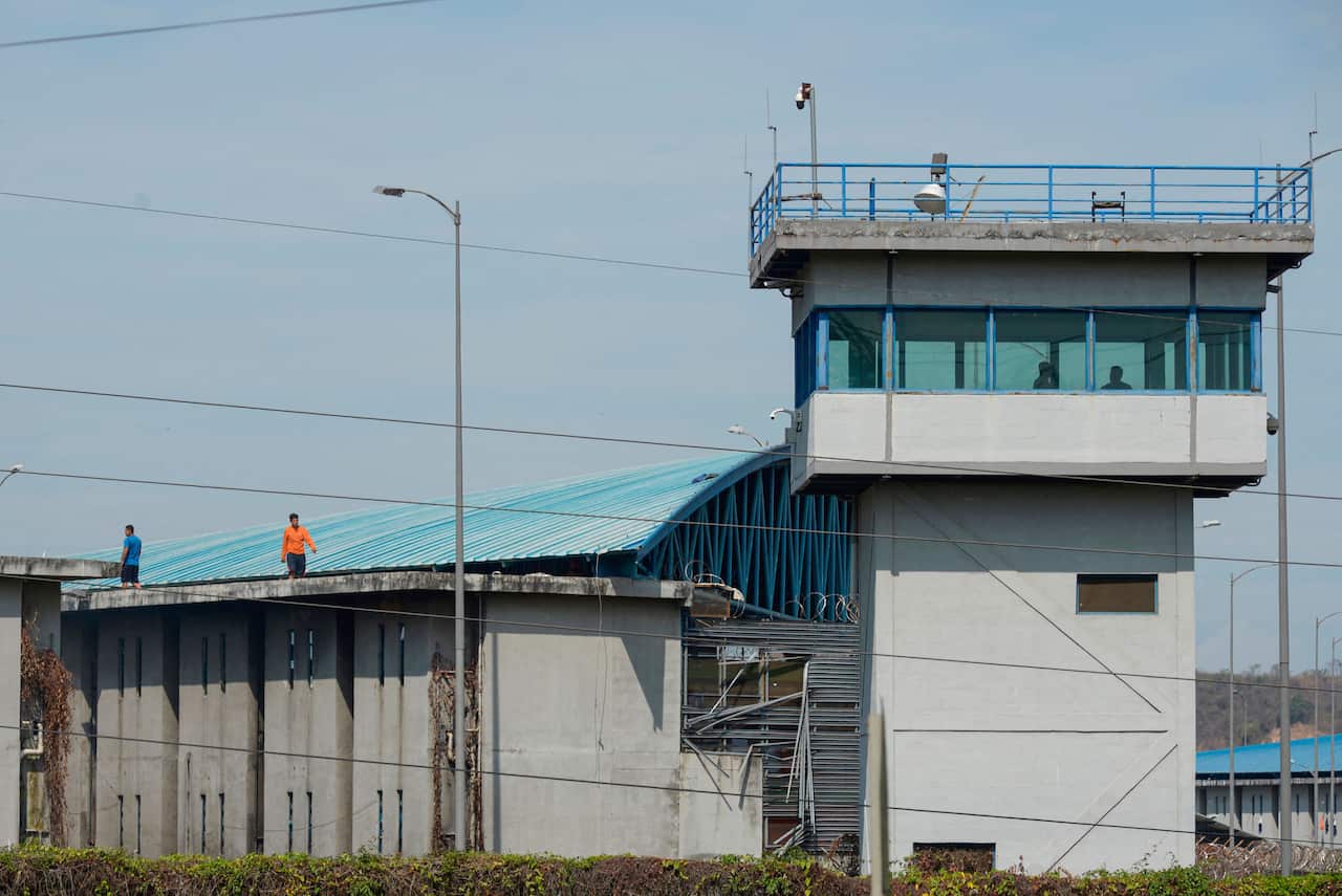 Inmates are seen on top of the prison roof during a riot at the Guayaquil Regional prison in Guayaquil, Ecuador on September 28, 2021.