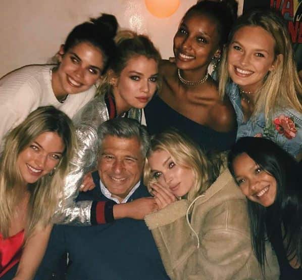 Former chief marketing officer Ed Razek poses for a photo with the Victoria's Secret angels.