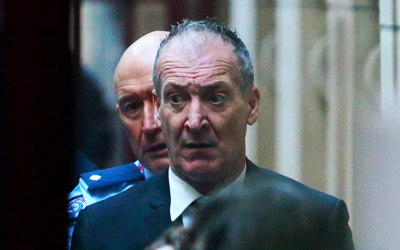 Angelo Russo is seen being loaded into a prison van as he leaves the Supreme Court of Victoria, Melbourne, Friday, July 20, 2018. 
