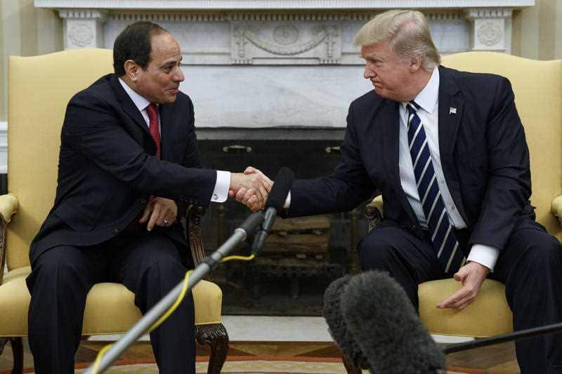 President Donald Trump shakes hands with the Egyptian president.
