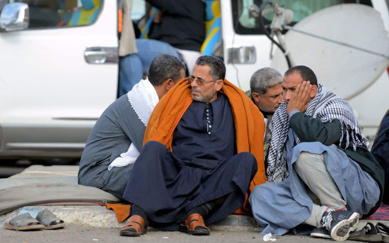 Relatives of the victims of the bomb and gun assault on the North Sinai Rawda mosque sit outside the Suez Canal University hospital.