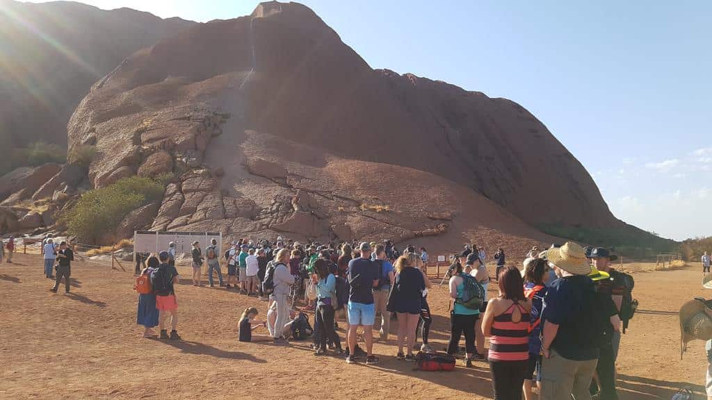 Hundreds line up to climb Uluru on the final day before the ban comes into force.