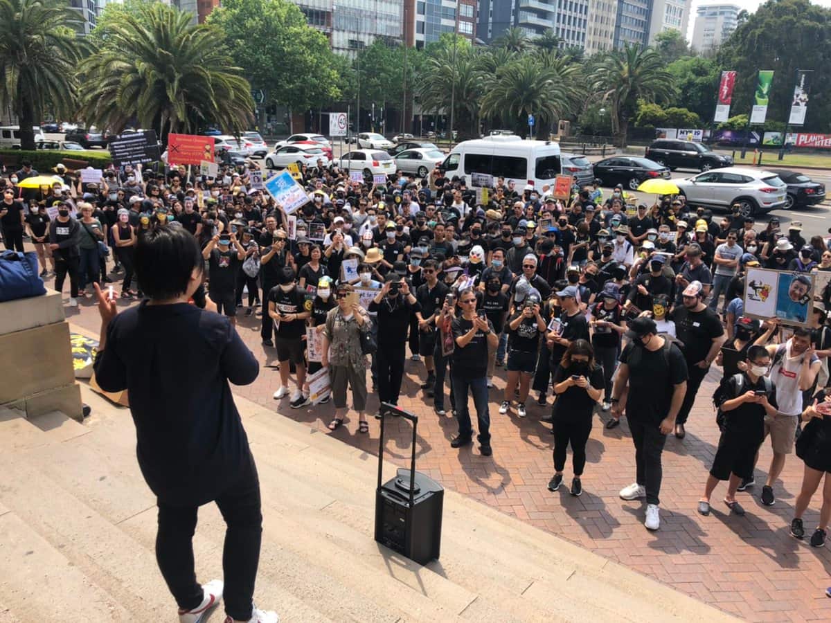 Former vice convener of civil human rights front Bonnie Leung addresses the rally in Sydney's CBD.