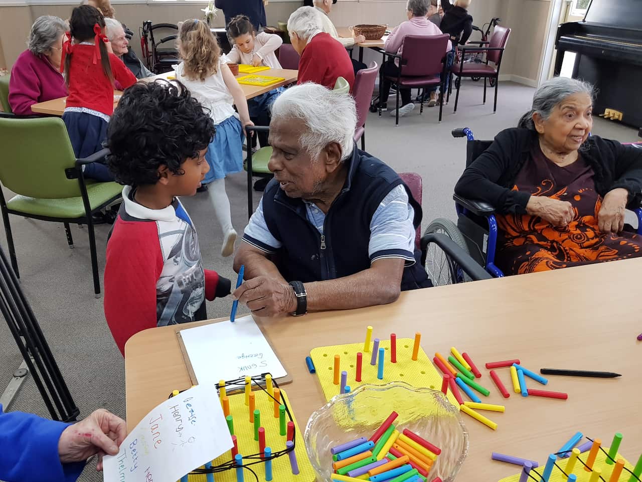 An aged care resident and preschooler chat