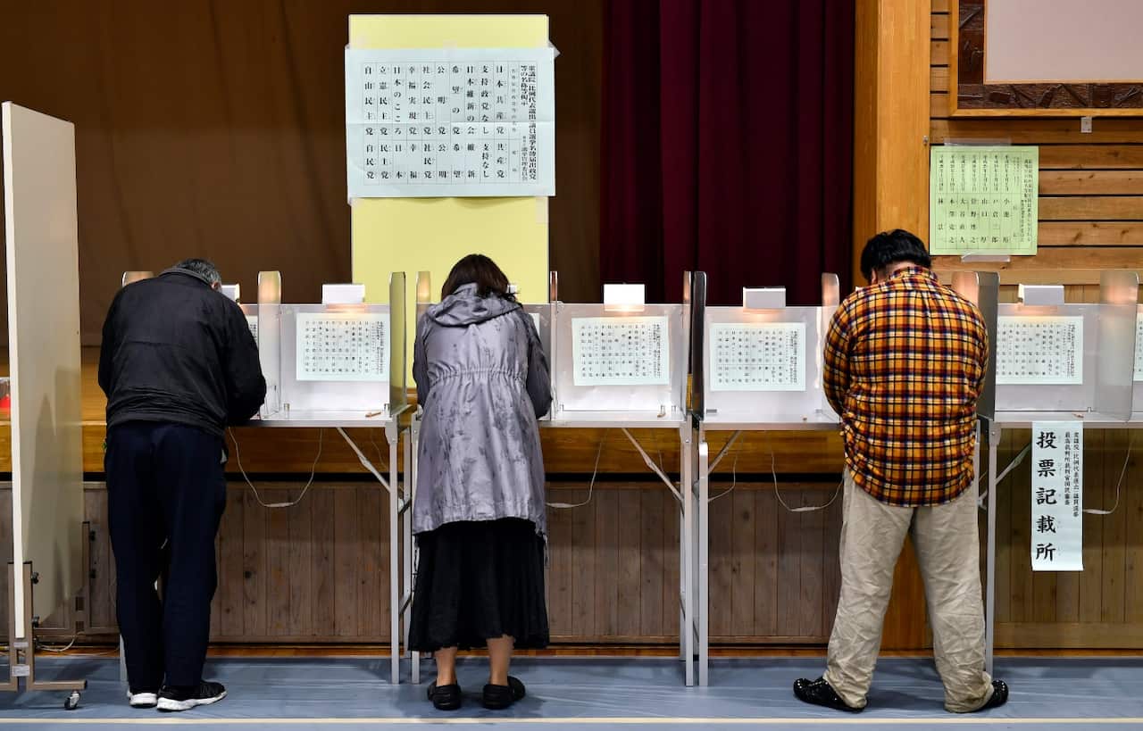 Voters fill their ballots for the lower house election at a polling station in Tokyo, Japan, 22 October 2017.