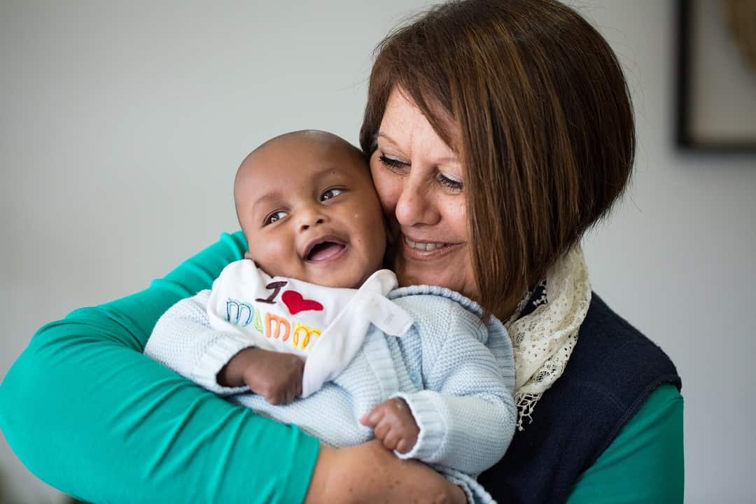 Doula, Elizabeth Mazeyko with five month old Kamaal at his home in Epping, Victoria. Photography by Krystal Seigerman, 2017.