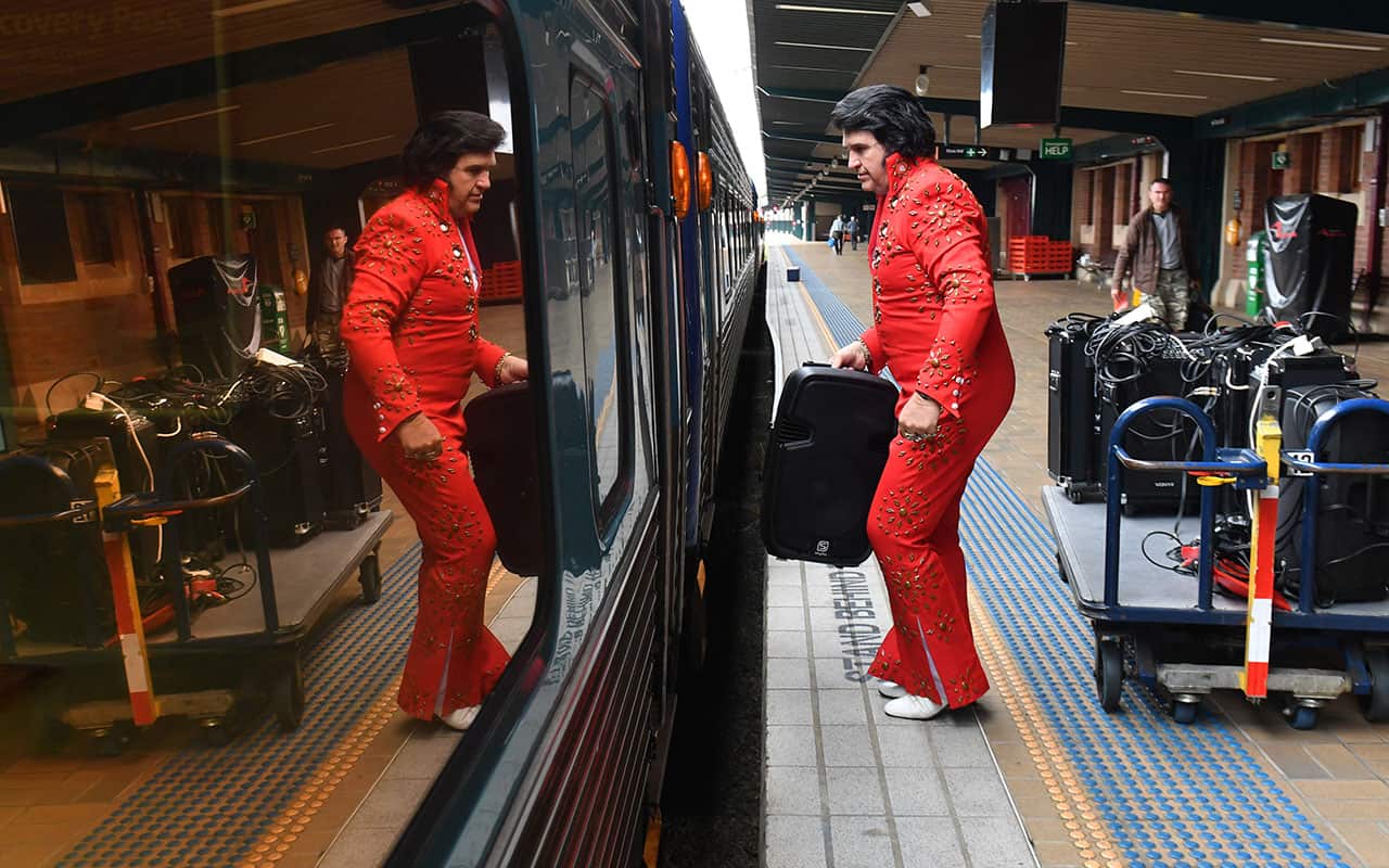An Elvis impersonator boards the Elvis Express at Central Station in Sydney, Thursday, January 11, 2018. 