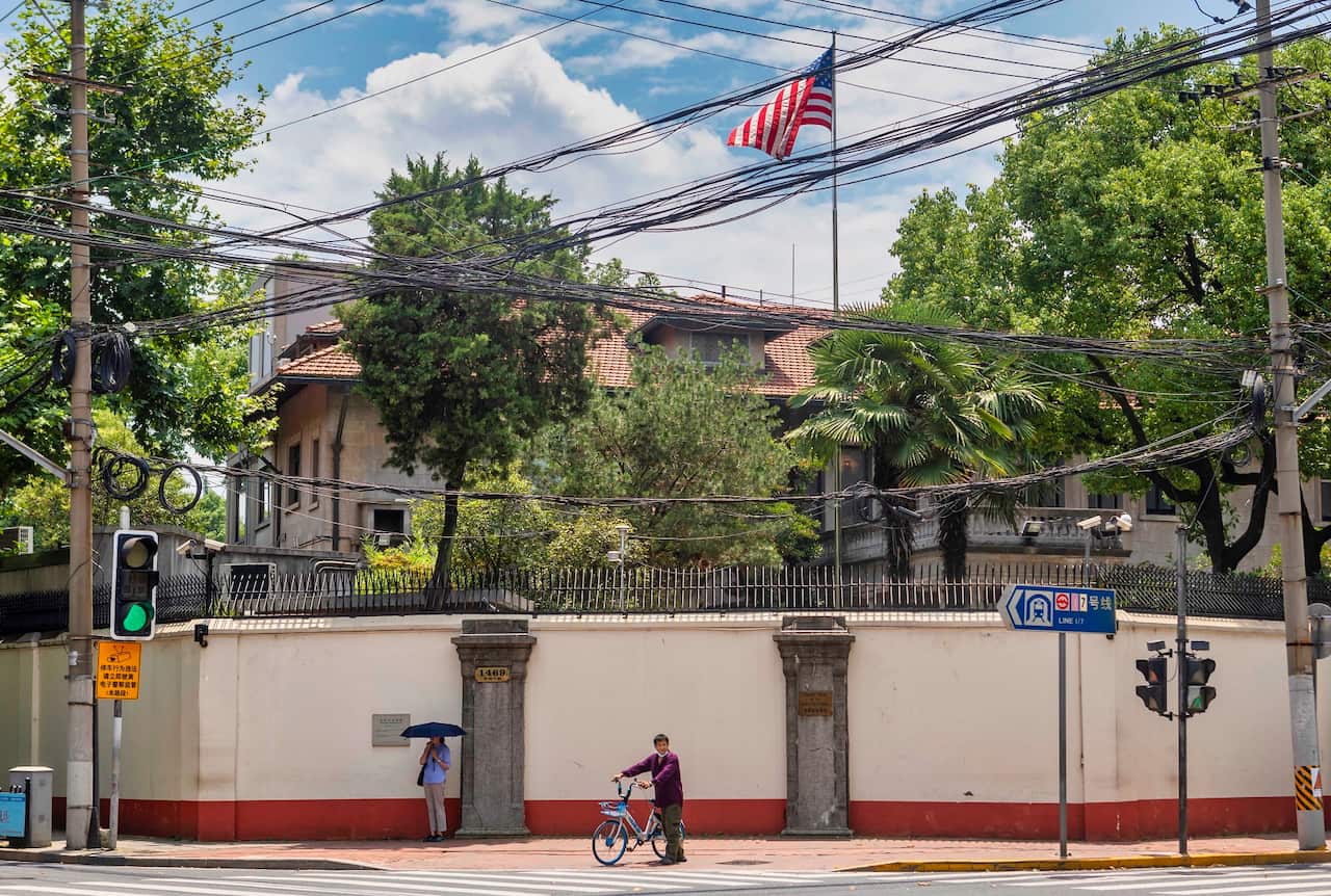 People stand in front of the US Consulate in Shanghai, China, 23 July 2020.