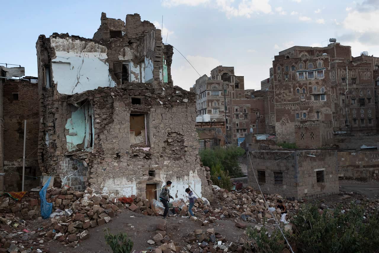 Boys play in the rubble of a home destroyed in an airstrike on the Old City of Sanaa, Yemen.
