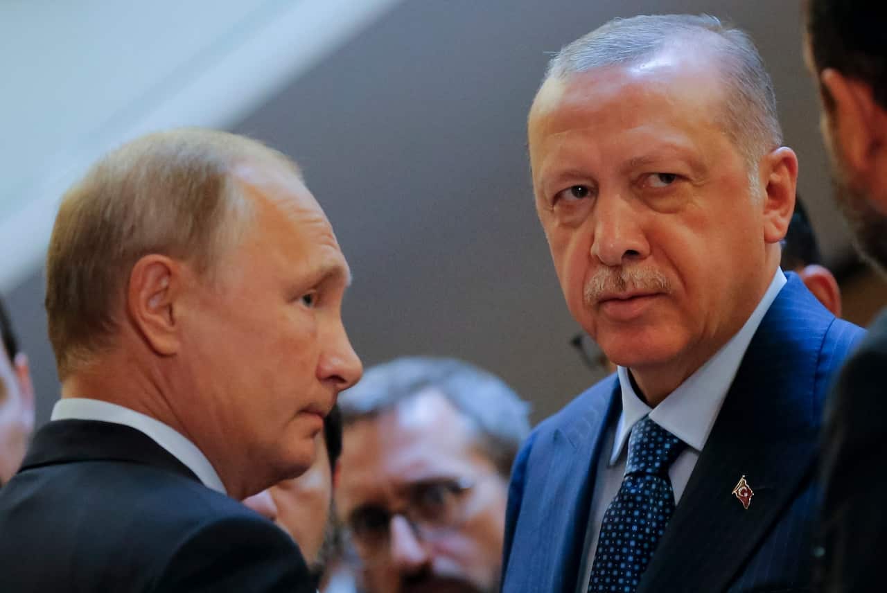 Russian President Vladimir Putin, (L) and Turkish President Recep Tayyip Erdogan prepare to enter a hall for their talks in the Bocharov Ruchei residence
