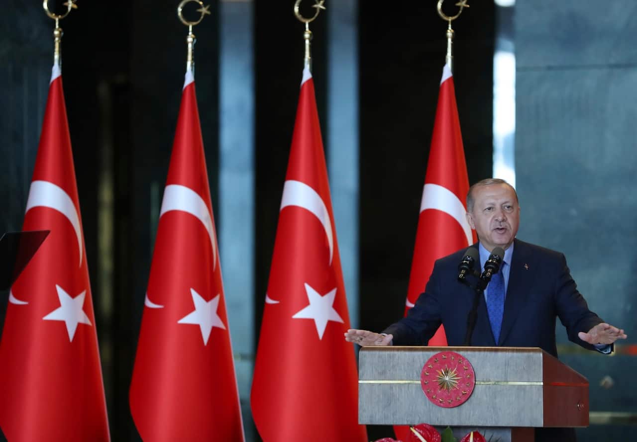 Turkey's President Recep Tayyip Erdogan, gestures as he delivers a speech to Turkish ambassadors at the Presidential Palace in Turkey, Monday, Aug. 13, 2018.