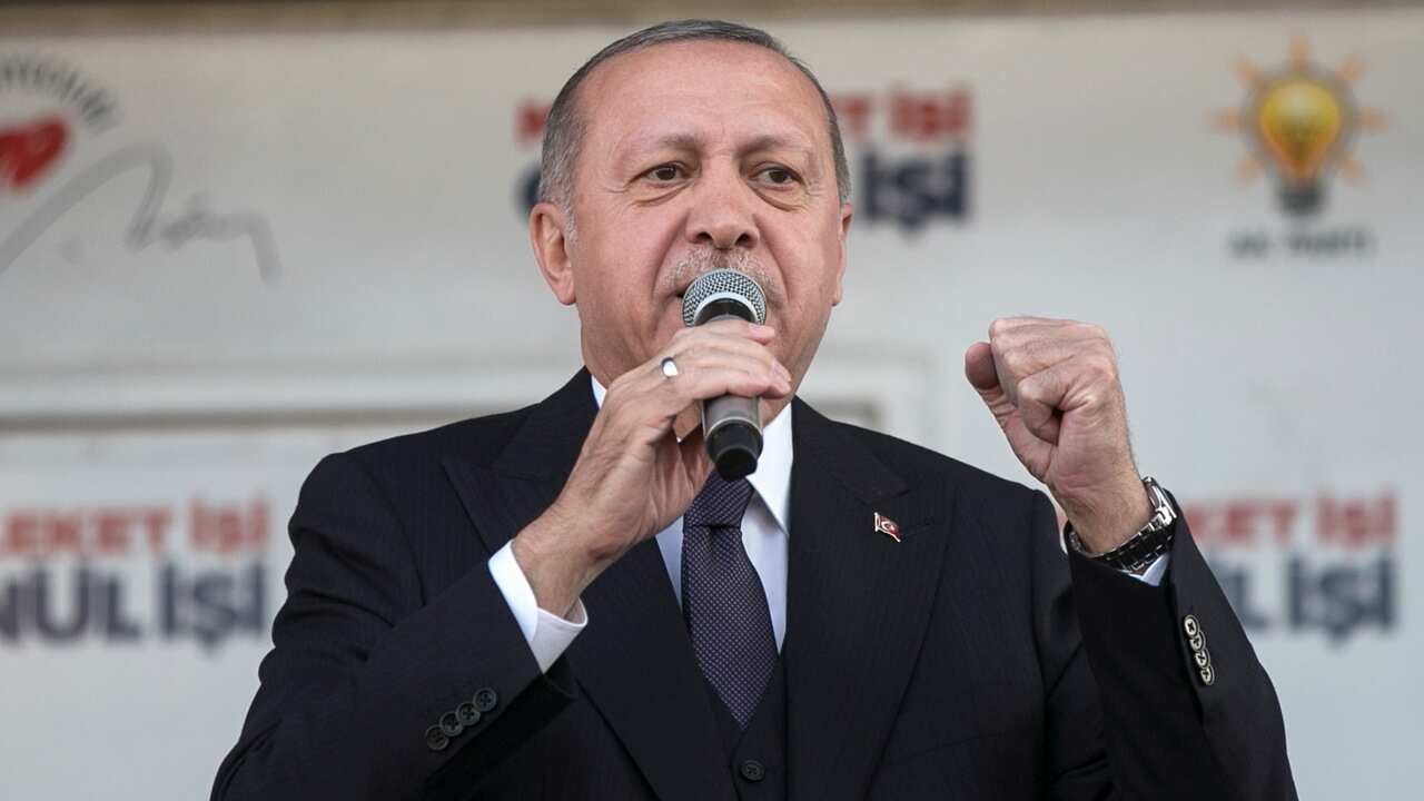 Turkish President Recep Tayyip Erdogan speaks into a microphone.