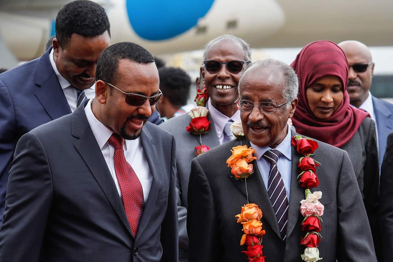 Ethiopia's Prime Minister Abiy Ahmed (left) walks with Eritrea's Foreign minister Osman Saleh Mohammed (right).