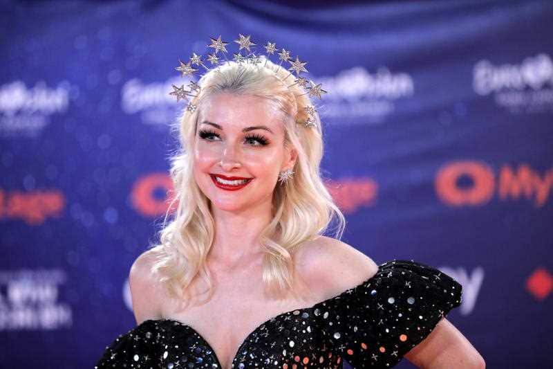 Kate Miller-Heidke walks the orange carpet.