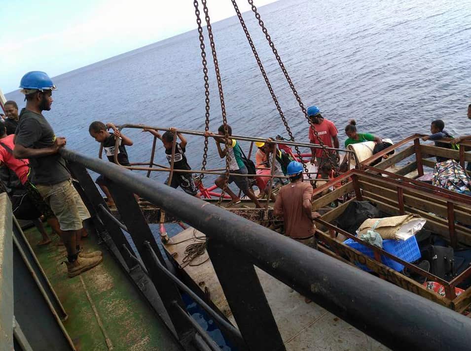 Children walk onto a boat as they are evacuated from the Pacific island of Ambae, which is part of Vanuatu.