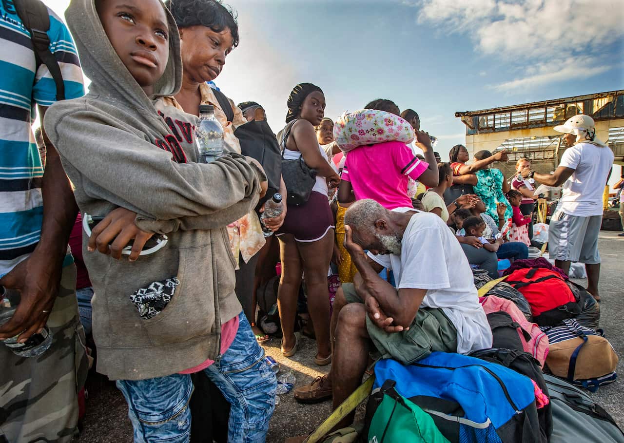 Evacuees wait for transportation to leave Marsh Harbour Port on Abaco Island.