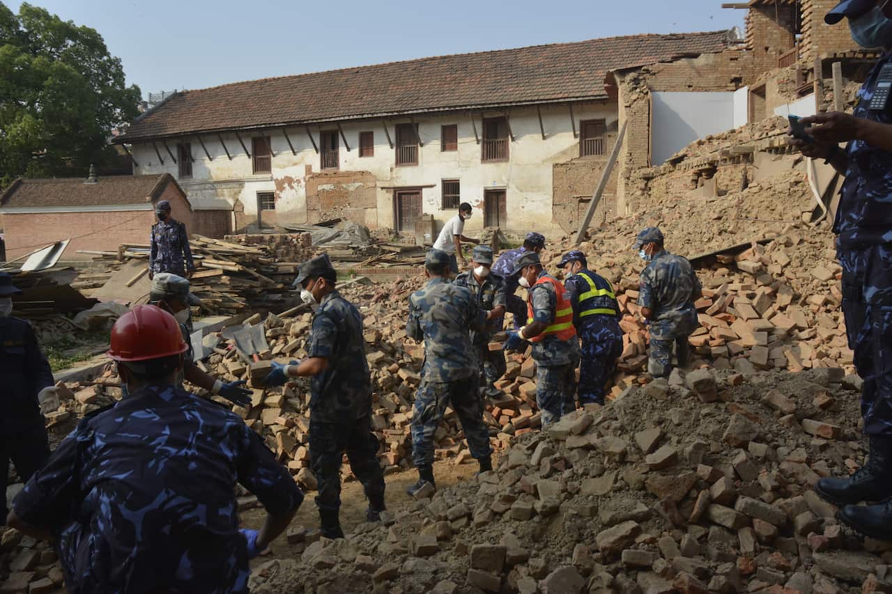 Ministers of Nepalese government along with Nepalese army, police and locals help in clearing the debris after the earthquake (AAP)