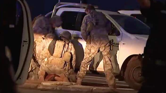 Members of the Territory Response Group (TRG) arrest a suspected gunman in Darwin. 
