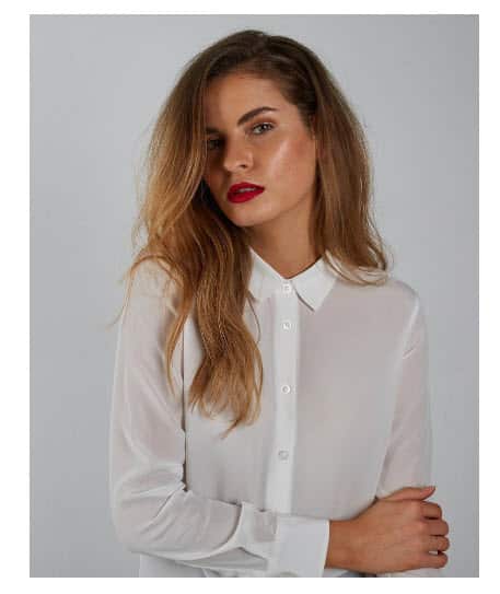 A model poses, wearing a Fable blouse.