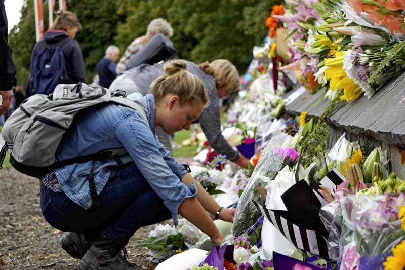 A woman places flowers near the site of the shooting in Christchurch.