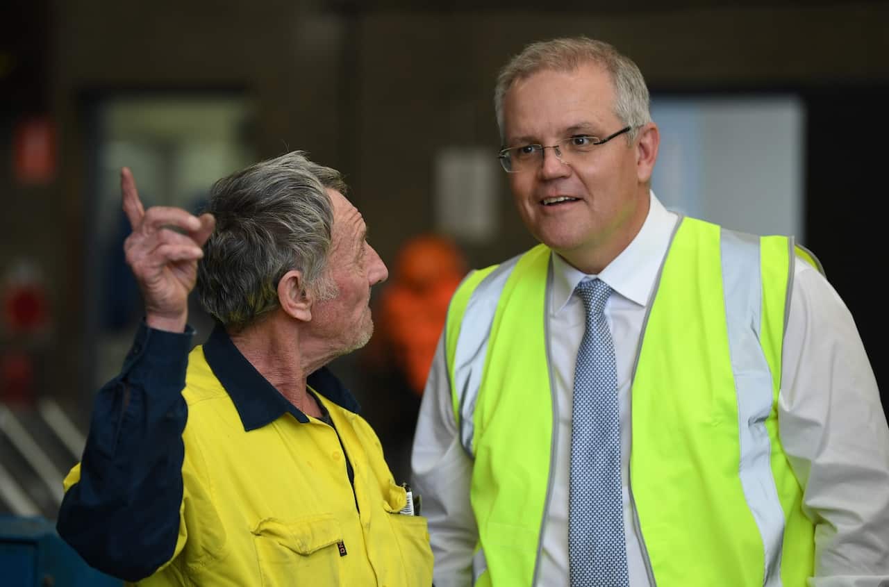 Australian Prime Minister Scott Morrison (right) talks to employee Michael Sheridan (left) during a visit to steel manufacturing business Galvatech