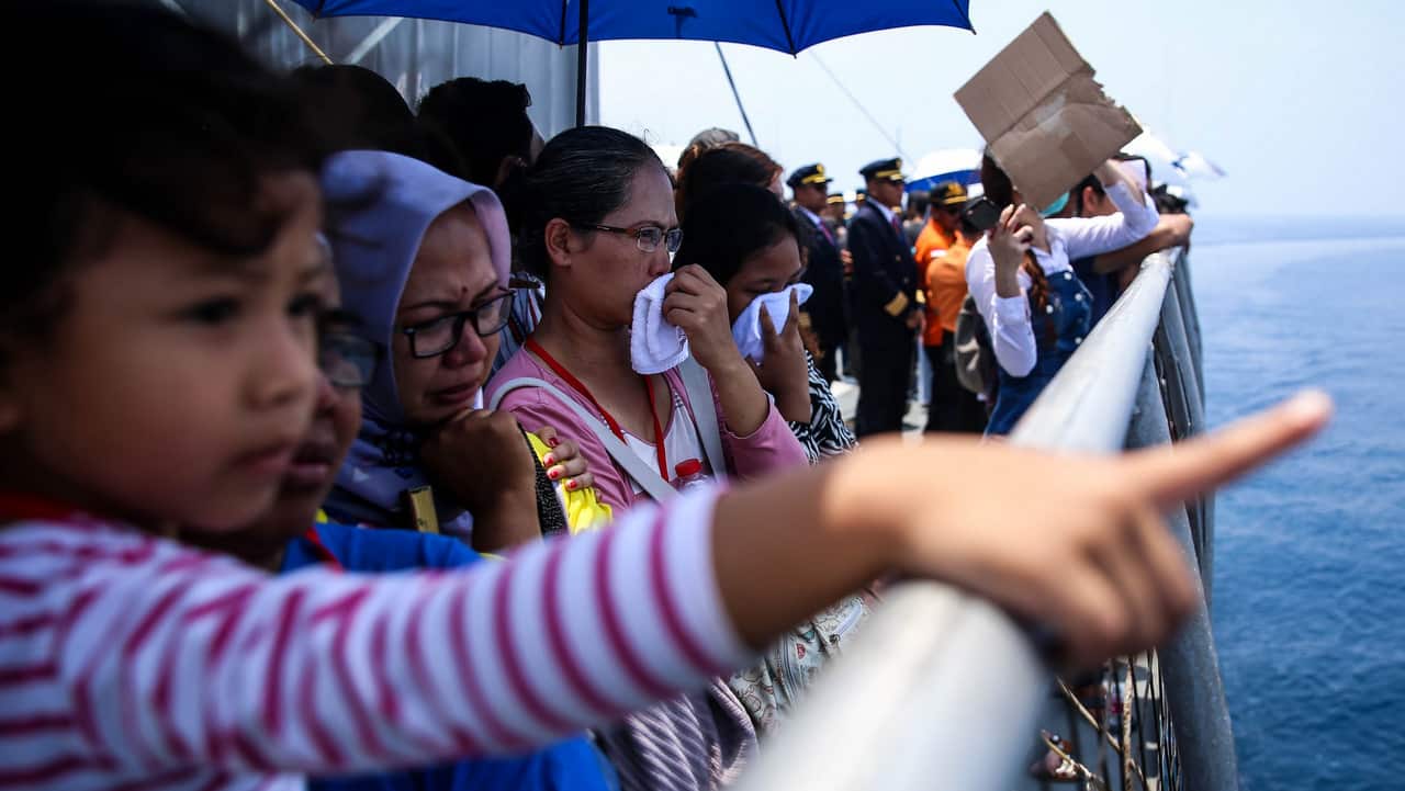 Families and colleagues of the victims of Lion Air flight JT610 pray and cry on the deck of an Indonesia Navy ship as they visit the site of the crash.