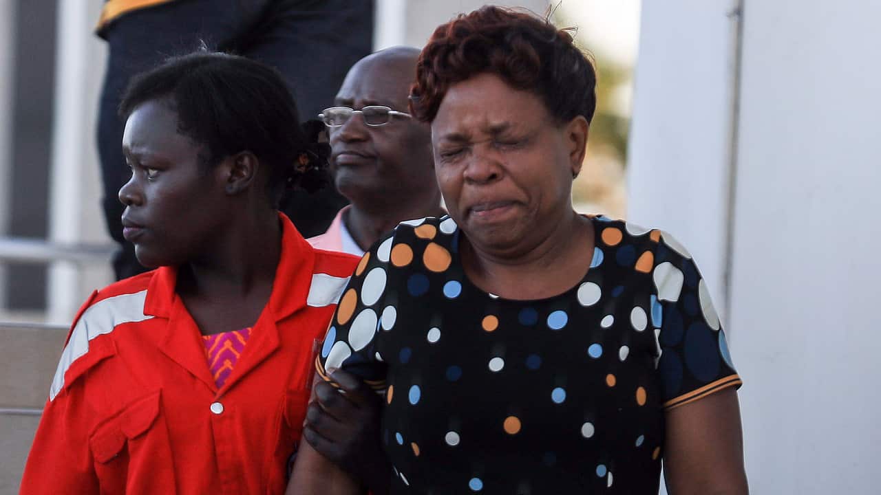 A Kenyan woman (R) is comforted by a Red Cross worker (L), after getting information about her loved ones that were on board the Ethiopian Airlines Flight 302.