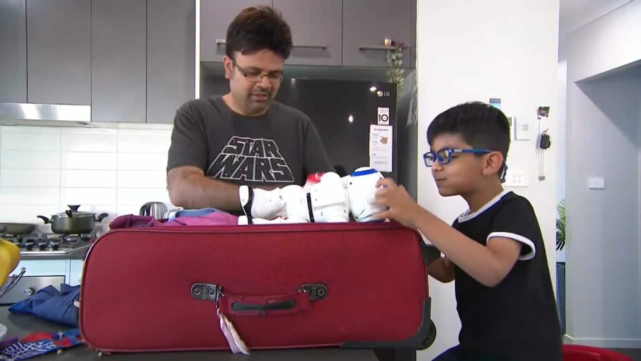 In Sydney, Umer Malik and his son pack their bags to visit family in Pakistan with international border restrictions lifting after a two-year hiatus. 