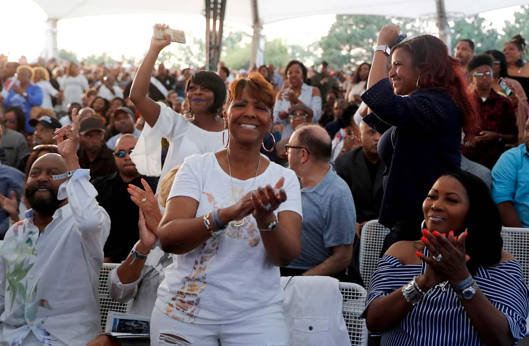 Fans clap and dance as they attend a tribute concert to Aretha Franklin at Chene Park Thursday, Aug. 30, 2018, in Detroit. Franklin died Aug. 16, 2018 of pancreatic cancer at the age of 76. (AP Photo/Jeff Roberson)