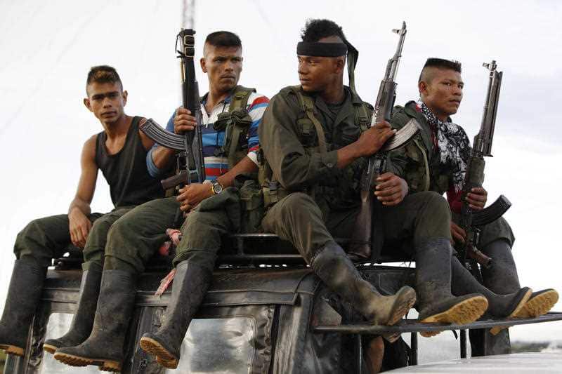 Rebels of the Revolutionary Armed Forces of Colombia, FARC, arrive on top of a truck to El Diamante, in southern Colombia, Friday, Sept. 16, 2016.