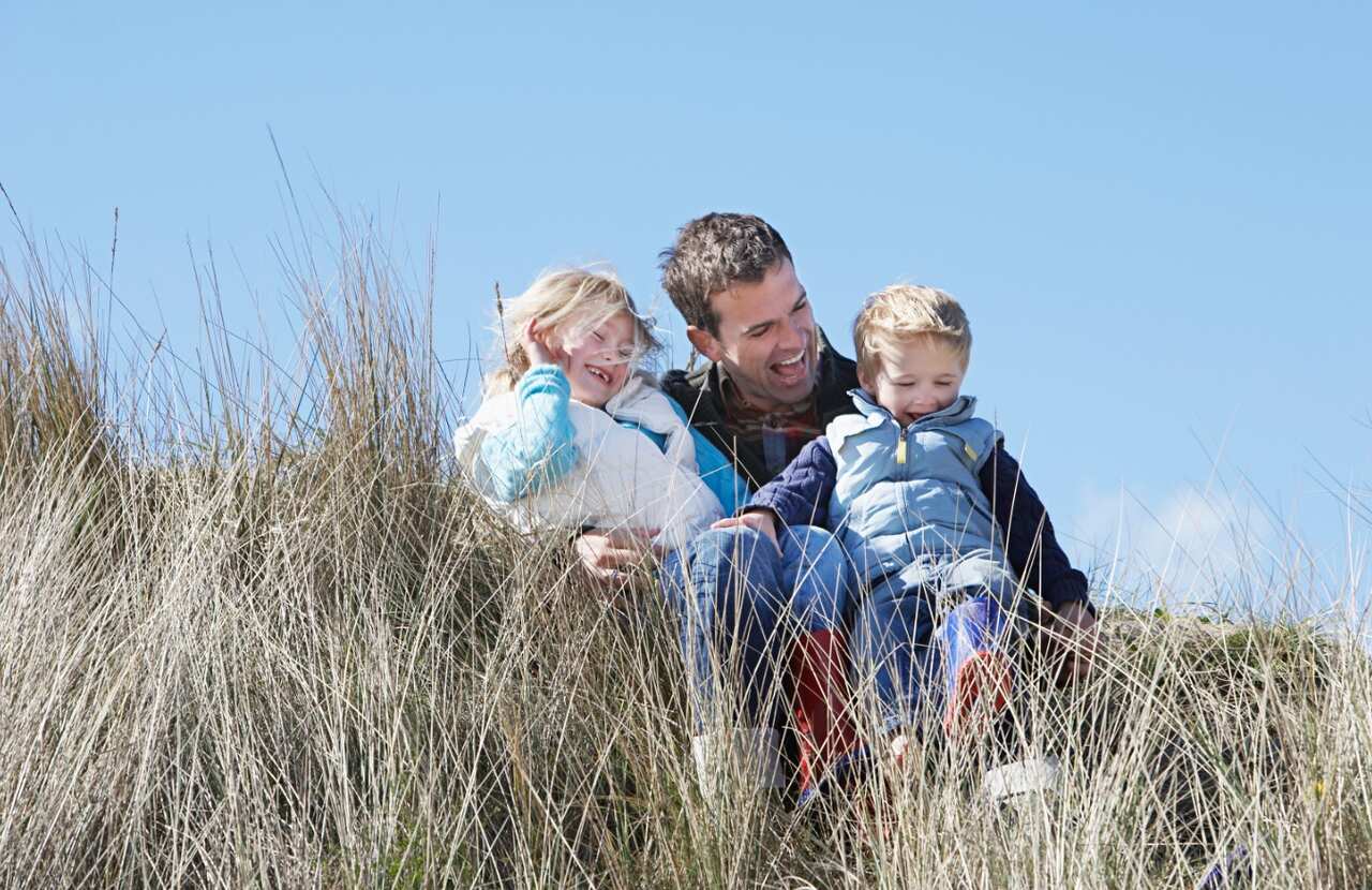 A file photo of a father with his two children (AAP)