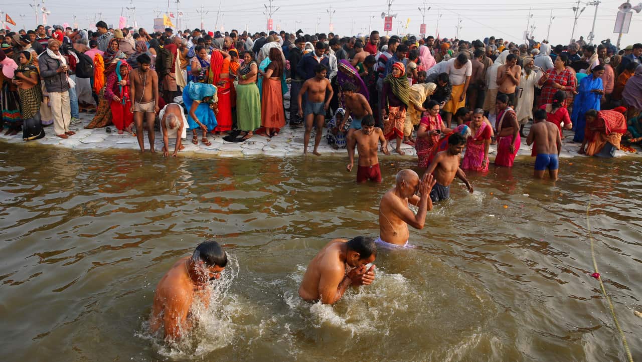 Hindu devotees take spiritual cleansing dips at the Sangam.