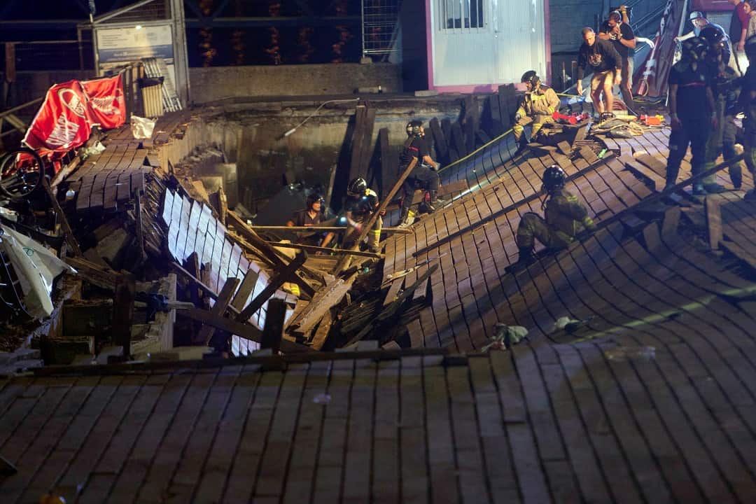 Firefighters search for victims after dozens of people fell into the sea during a concert in Vigo, northwestern Spain.