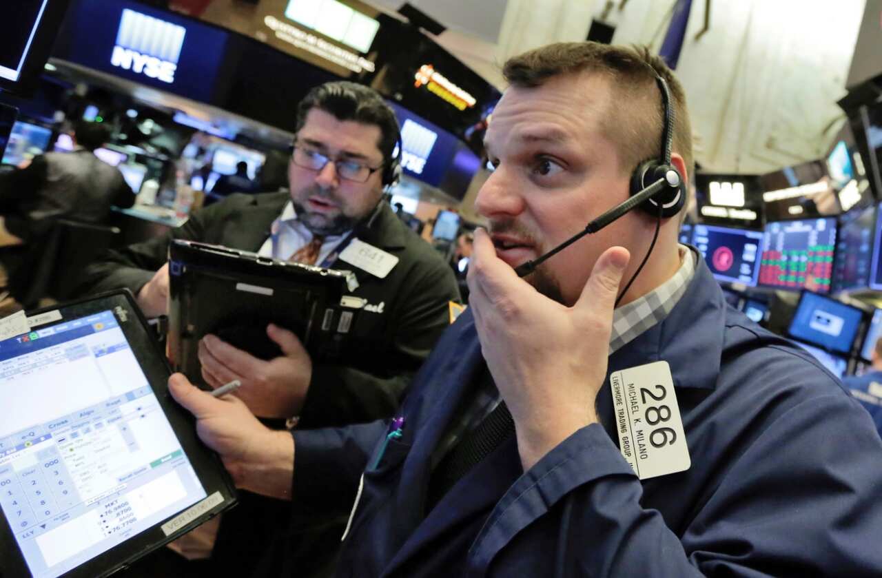 Trader Michael Milano, right, works on the floor of the New York Stock Exchange, Thursday, Feb. 8, 2018. 