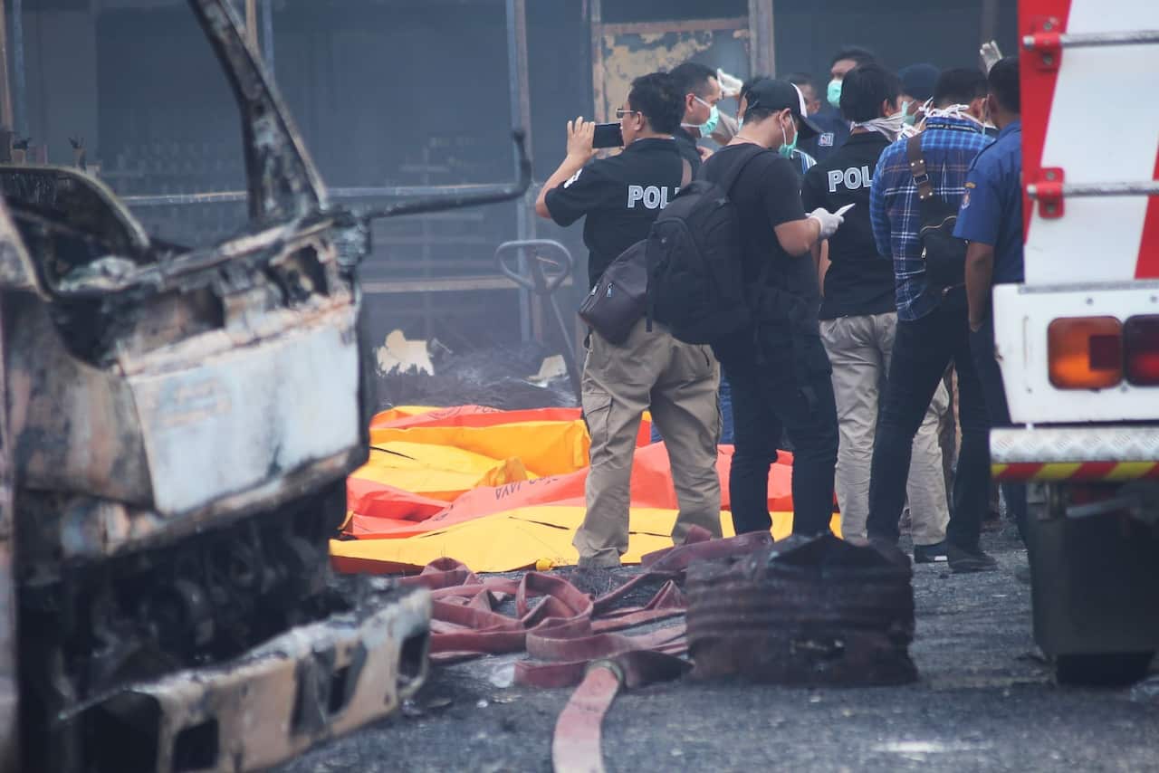 Indonesian forensic policemen work after a fire disaster in Tangerang Kota, Banten province on October 26, 2017 (Getty)