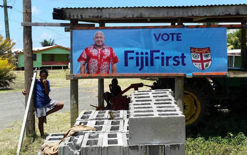 A a FijiFirst poster with the image of Fiji Prime Minister Frank Bainimarama, who has regained a majority.